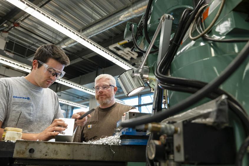 Student and instructor working at MILL machine